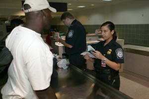 Airlines officer checking a passenger's document