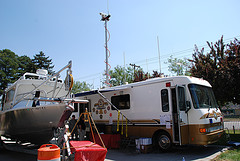 A boat and a motor home on a parking ground