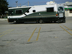 Long black and white motorhome in a parking lot